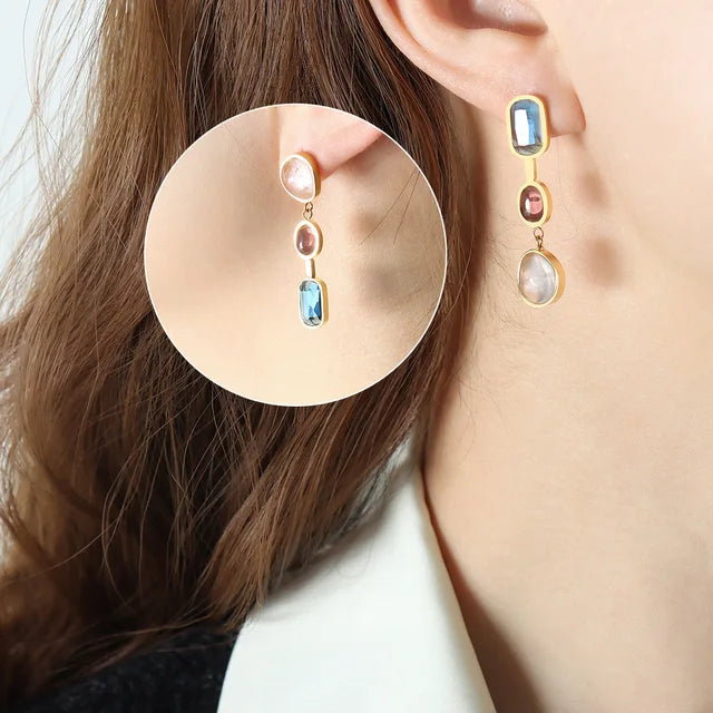 Female earrings with contrasting crystal and glass stone inlaid design