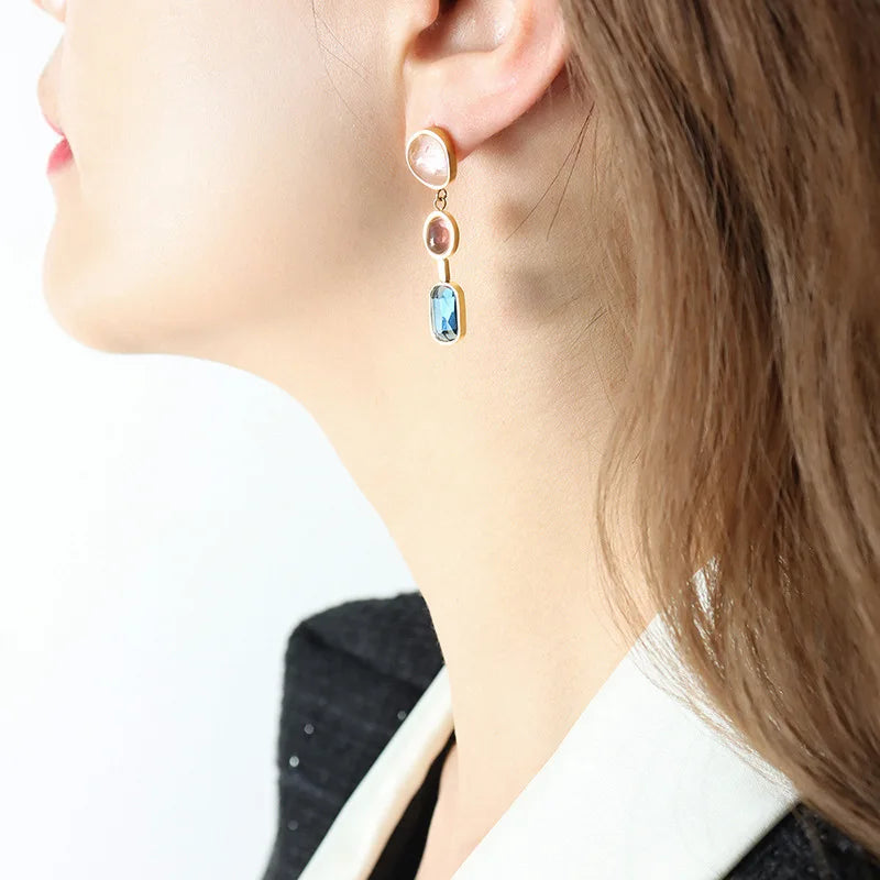 Female earrings with contrasting crystal and glass stone inlaid design